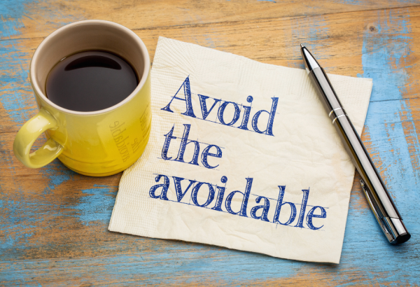a cup of coffe on a napkin that says: "avoid the avoidable"